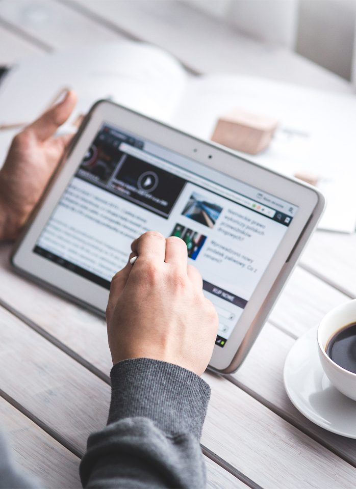 Person using a tablet on a table.