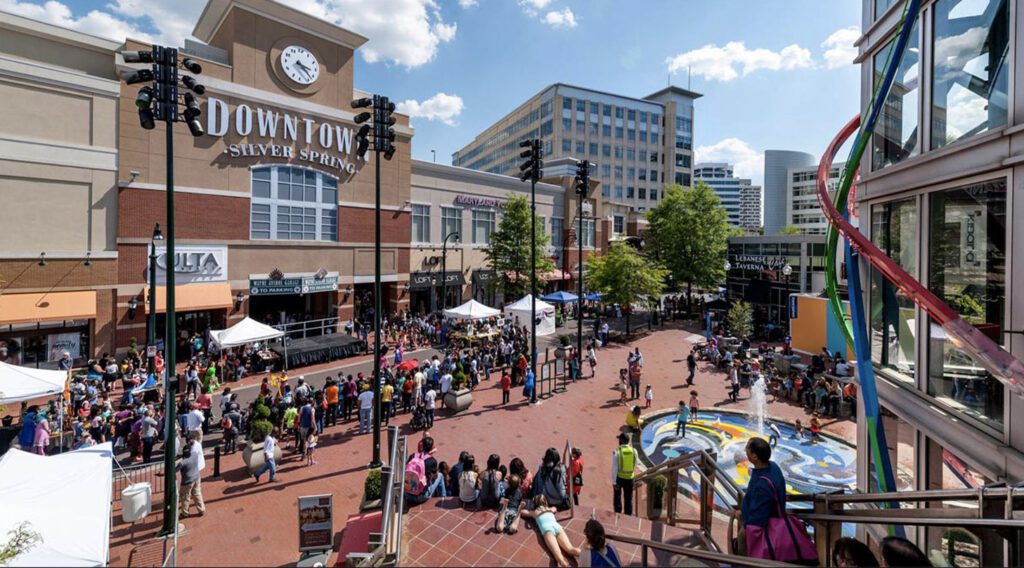 Downtown Silver Spring with a fountain and crowd.