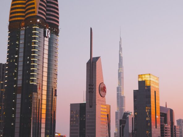 Cityscape of Dubai skyscrapers at sunset.