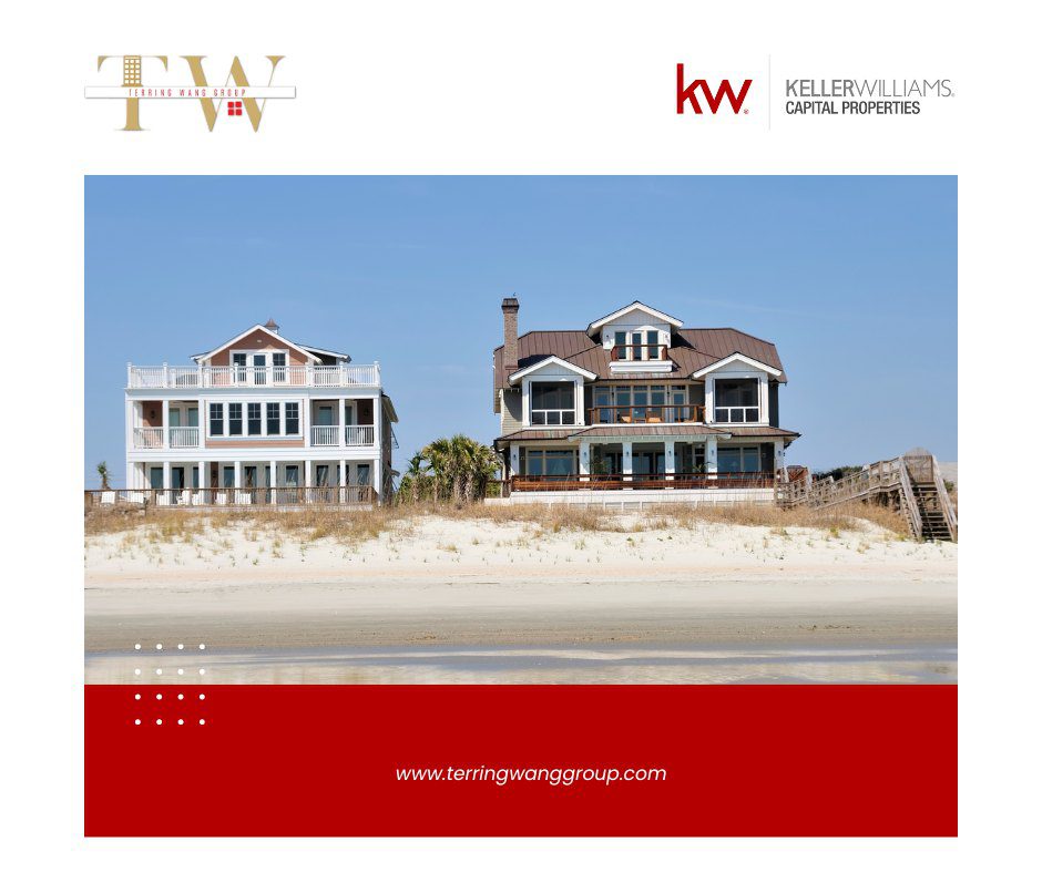 Two beach houses on a sandy shore.