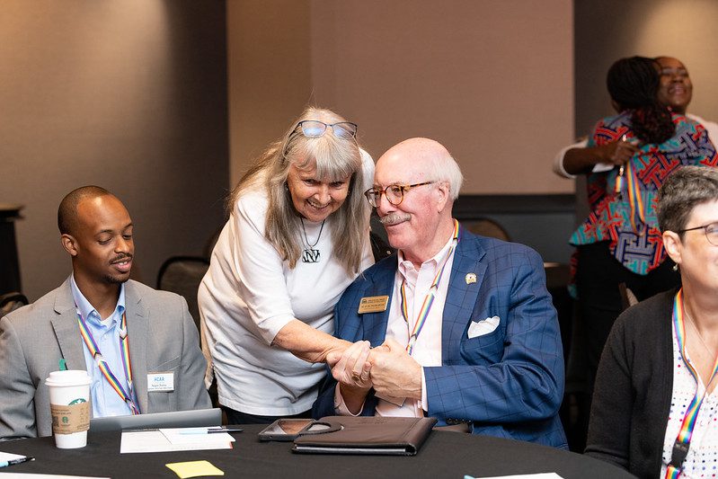 Two men and two women at a conference.