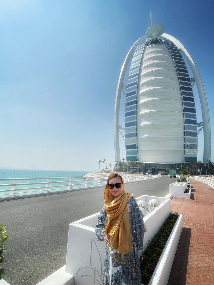 Woman in hijab in front of Burj Al Arab.