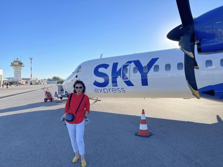 Woman posing with airplane in the background