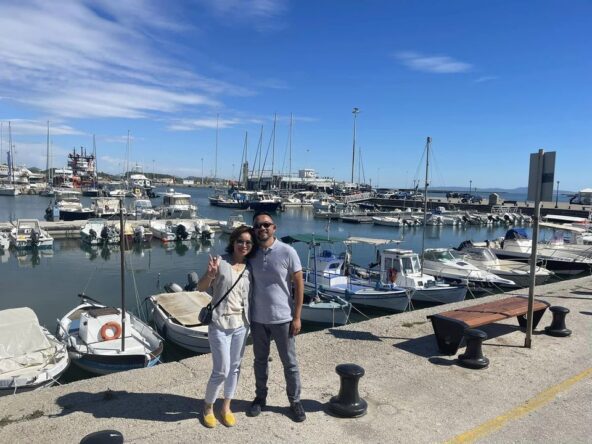 Couple posing with ships in the background