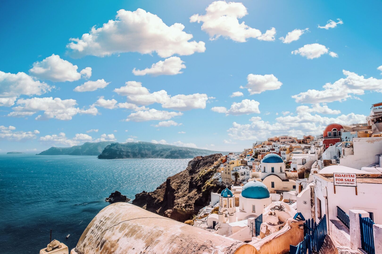 White houses on a cliff overlooking the sea.