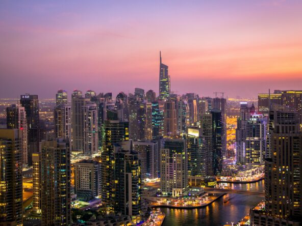 Dubai skyline at dusk with water.