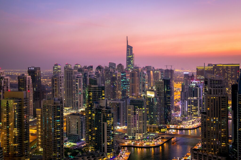 Dubai skyline at twilight with water.