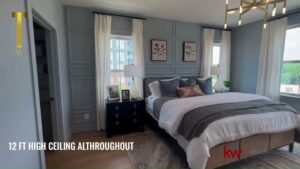 Bedroom with high ceilings and large windows.