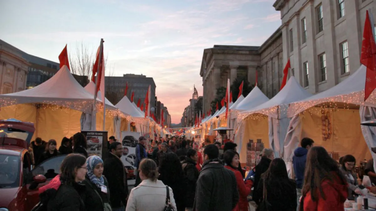 Outdoor market with tents and lights.