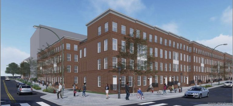 Brick apartment building with street view.