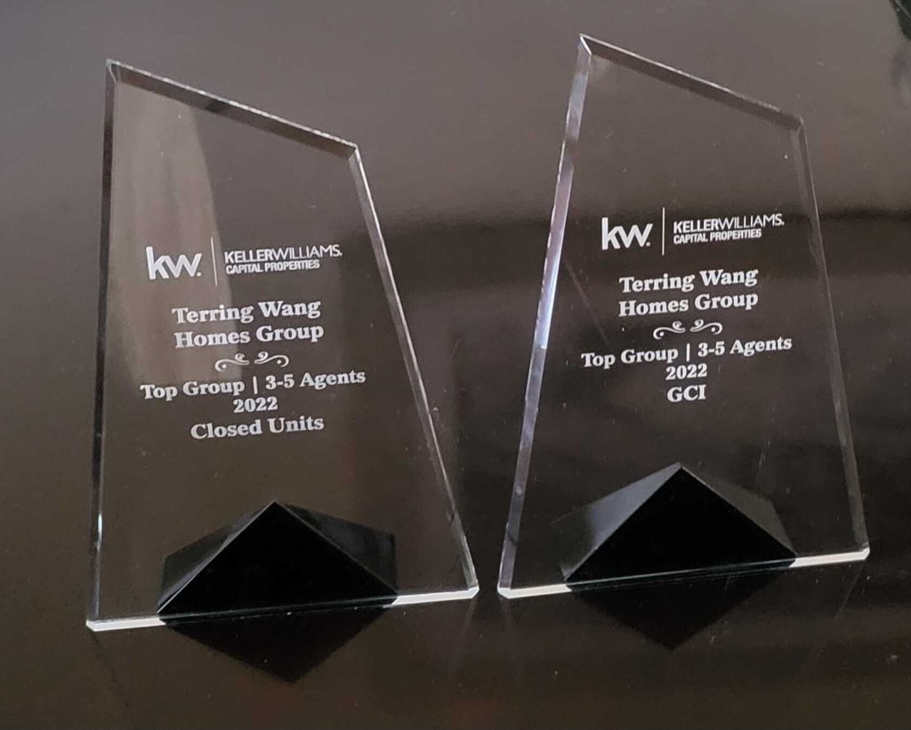 Two engraved glass awards on a table.