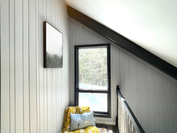 Cozy nook with cushions and window.