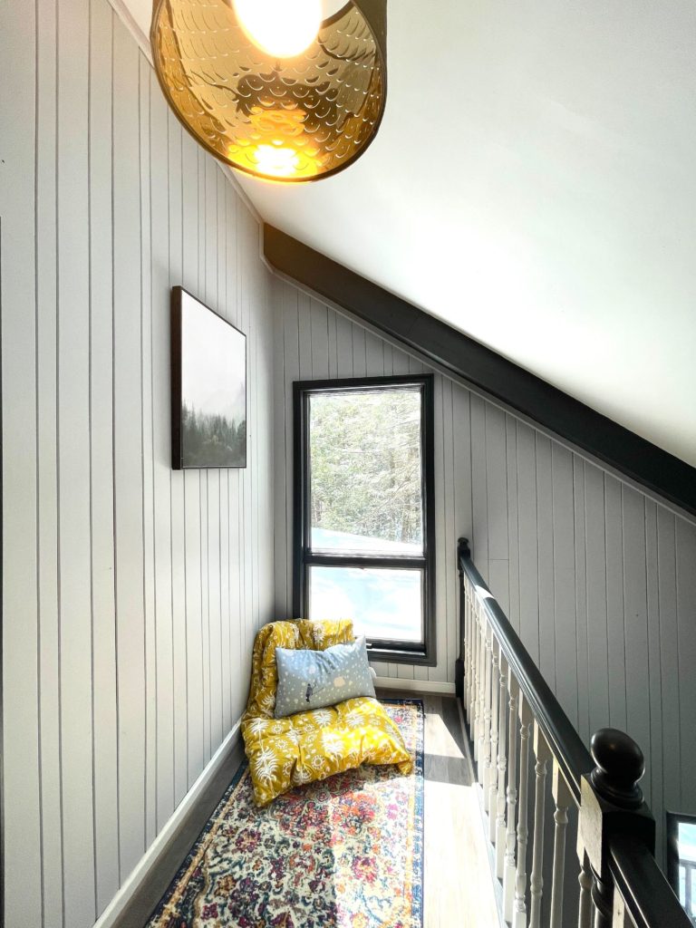 Cozy nook with cushions and window.