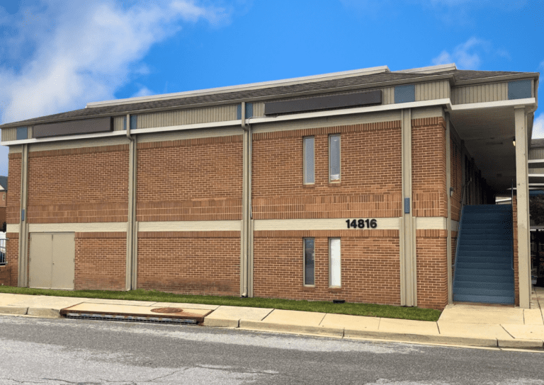 Brick building with exterior staircase entrance.