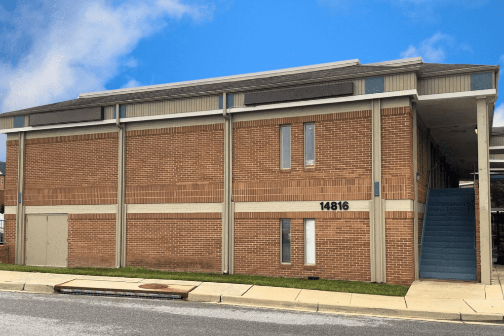 Brick building with stairs and blue sky.